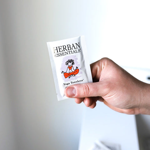 holing a single herban essentials lavender yoga wipe